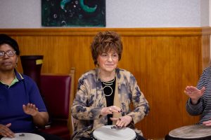 woman playing african drums in room